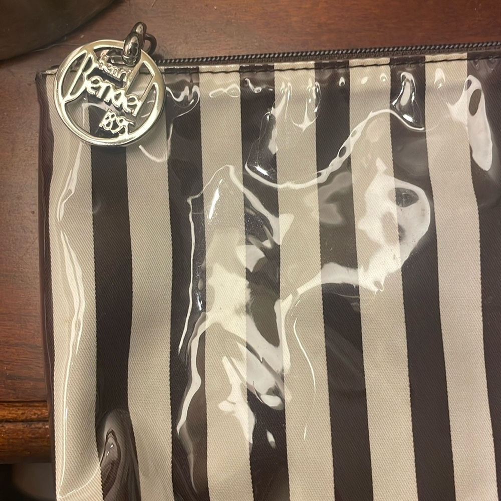 Henri Bendel Makeup Bag.Plastic over brown and white silky bag